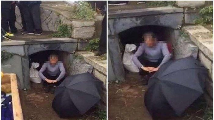 seorang perempuan menangis di depan kuburan ayah mertuanya